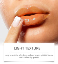 Close-up of woman applying light texture lip gloss on lips with finger