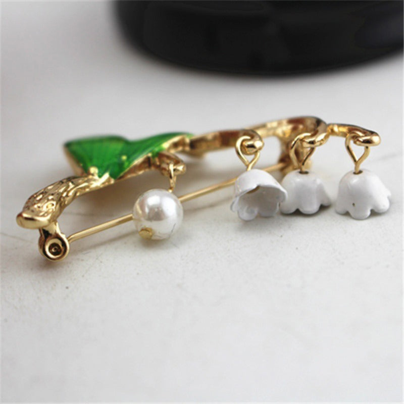 Green drip-glazed lily of the valley brooch