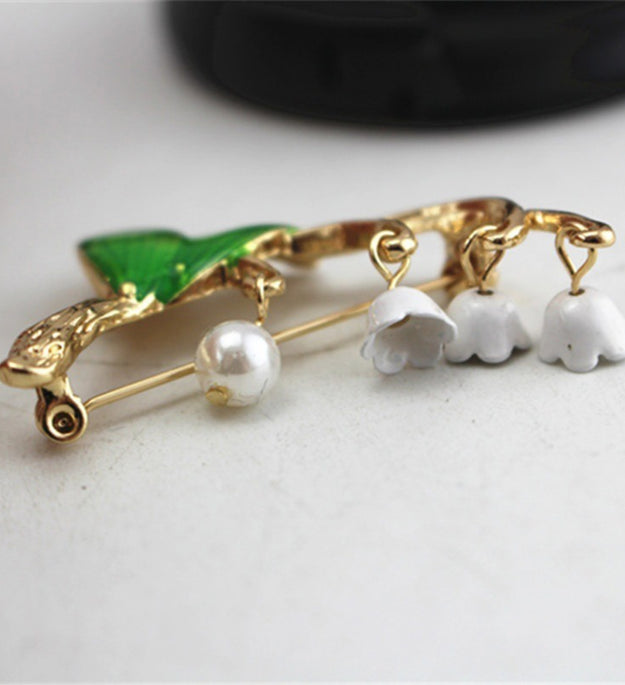 Green drip-glazed lily of the valley brooch