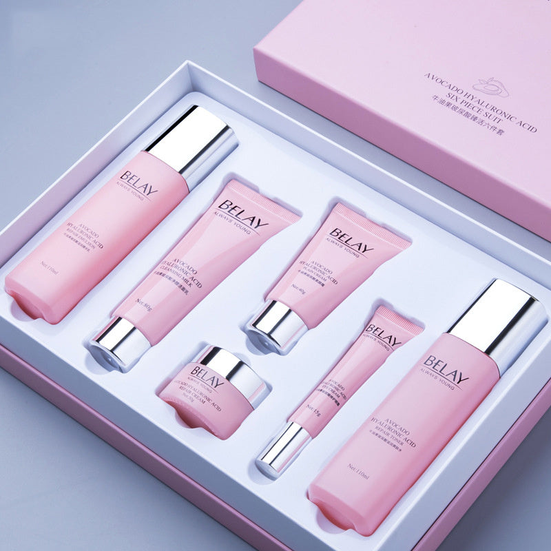 Pink facial care cosmetics set with multiple skincare products in a white and pink box