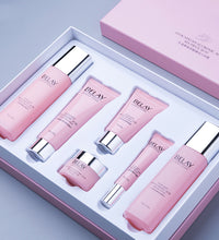 Pink facial care cosmetics set with multiple skincare products in a white and pink box