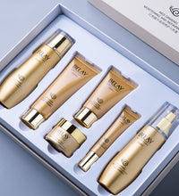 Gold and beige facial care cosmetics set with six moisturizing and repairing products in a white box