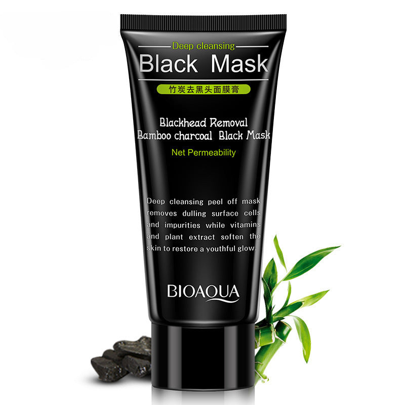 Bamboo charcoal blackhead mask in a black tube with bamboo leaves and charcoal pieces for deep cleansing