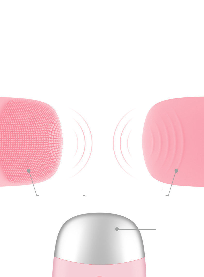 Pink electric silicone face cleansing brush showing soft bristles and vibration indicators