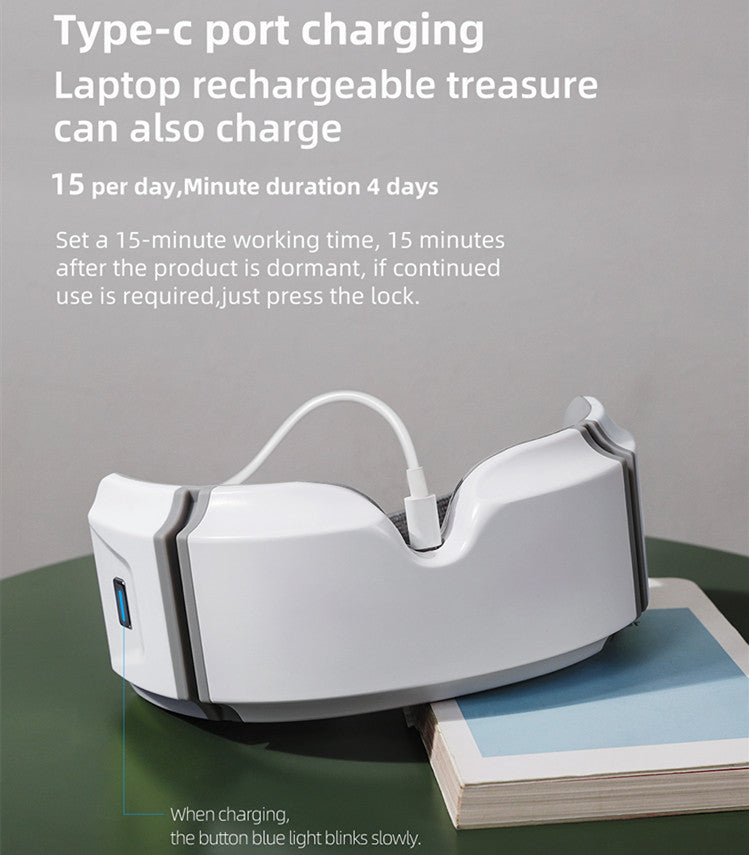White eye heating massager with USB Type-C charging port placed on books with charging instructions