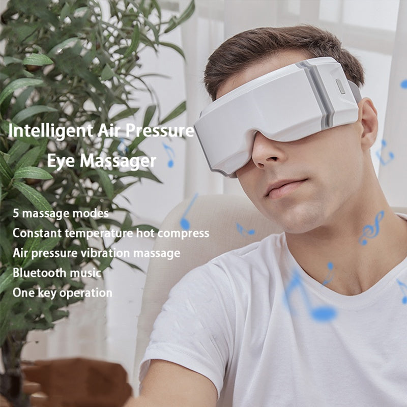Man using white eye heating massager with intelligent air pressure and Bluetooth music features