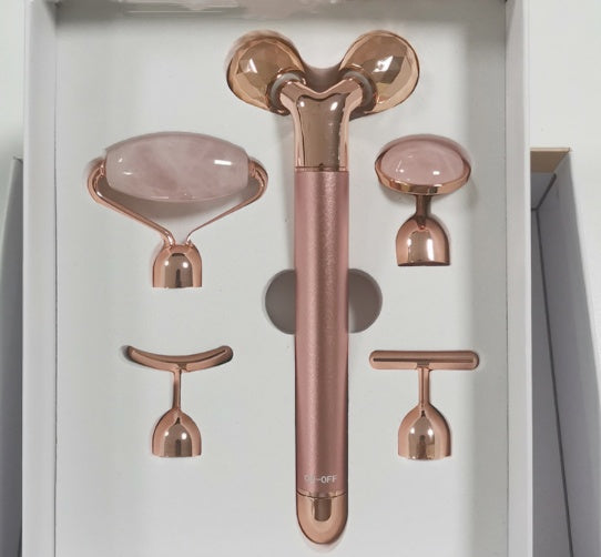Rose gold 5-in-1 facial massage tool set with multiple interchangeable heads for skincare