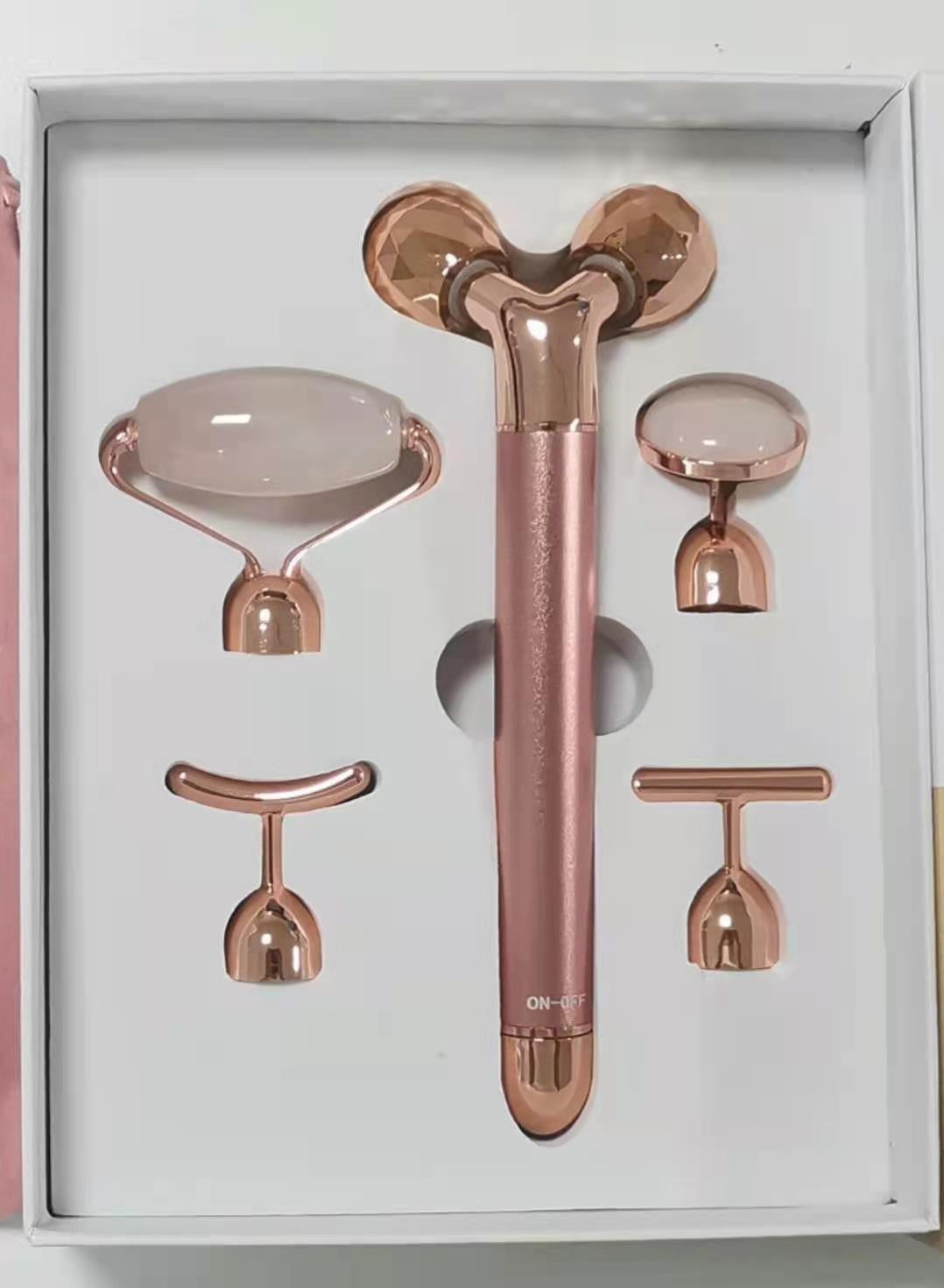 Rose gold 5-in-1 facial massage tool set with multiple interchangeable heads in white packaging