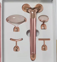 Rose gold 5-in-1 facial massage tool set with multiple interchangeable heads in white packaging