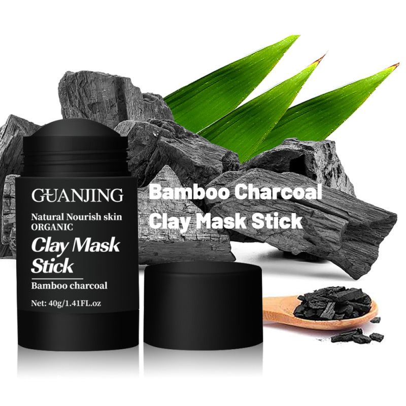 Organic bamboo charcoal face mask stick with natural bamboo charcoal and green leaves background