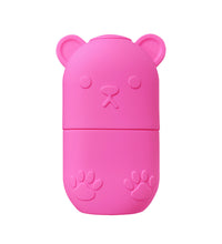 Pink bear-shaped ice face roller for skincare with paw print details on the case