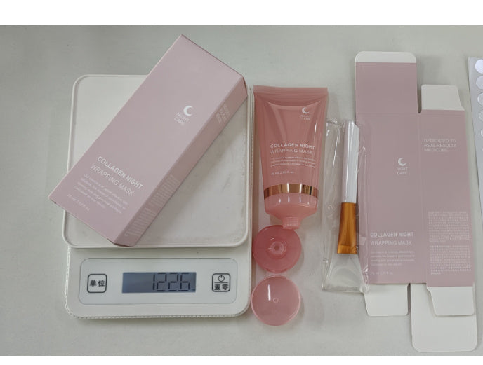 Pink collagen night anti-wrinkle overnight mask tube with box and applicator on digital scale
