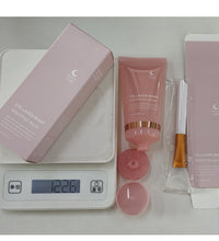 Pink collagen night anti-wrinkle overnight mask tube with box and applicator on digital scale