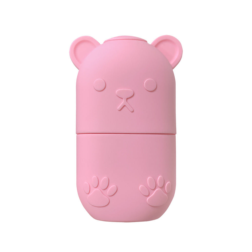 Cute pink bear-shaped ice face roller for skincare with paw print details