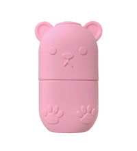 Cute pink bear-shaped ice face roller for skincare with paw print details
