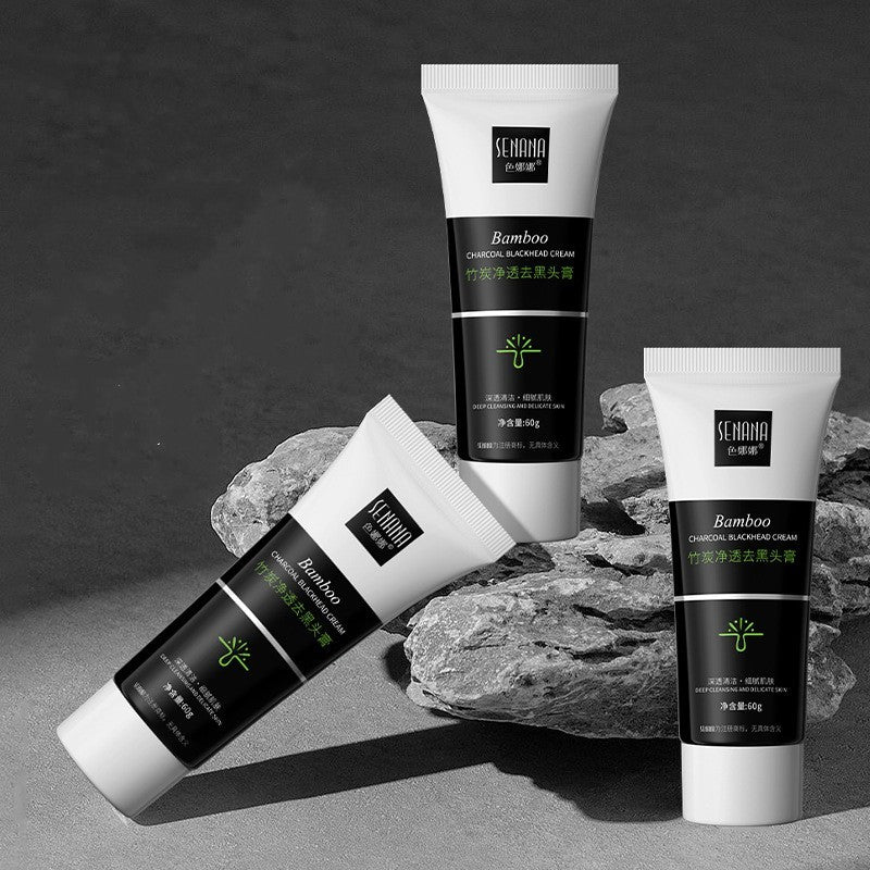 Bamboo charcoal blackhead remover cream tubes arranged on gray rocks with black and white packaging